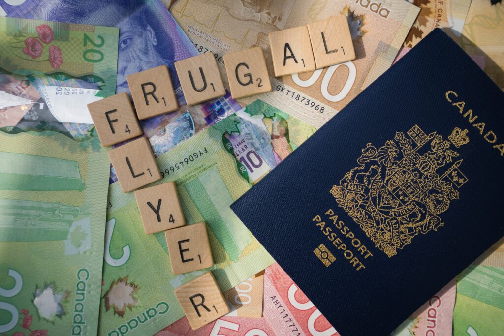 Canadian passport on Canadian dollar bills with “Frugal Flyer” letters, illustrating frugal living tips for budget travel and smart saving.