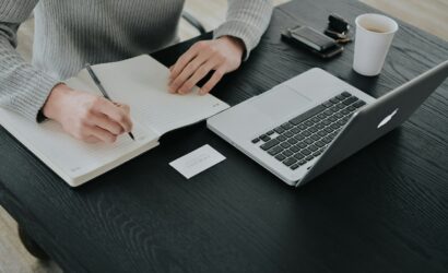 A woman sitting at a laptop, working while reviewing dividend stocks, illustrating passive income with dividend stocks strategy.